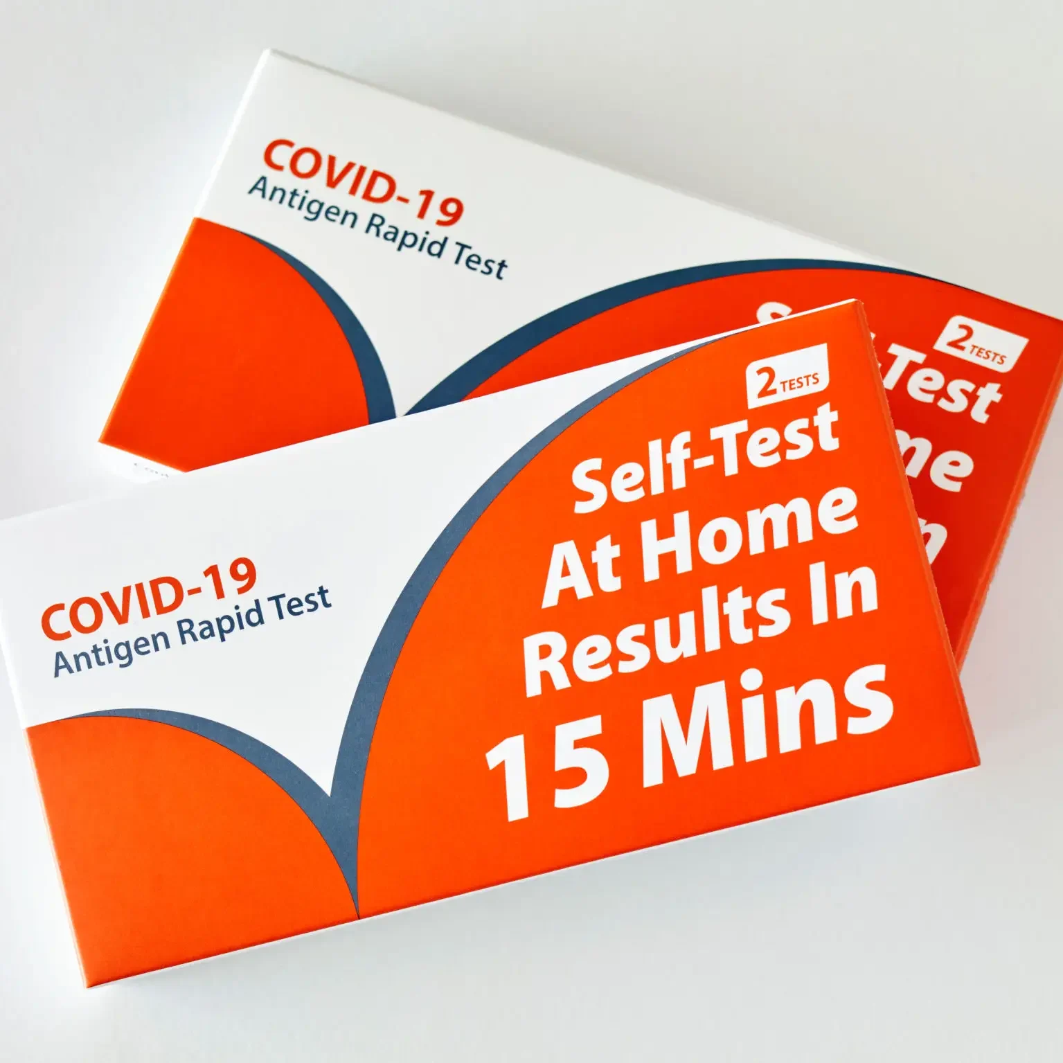 A close up of two boxes with the words " self-test at home results in 1 5 minutes ".